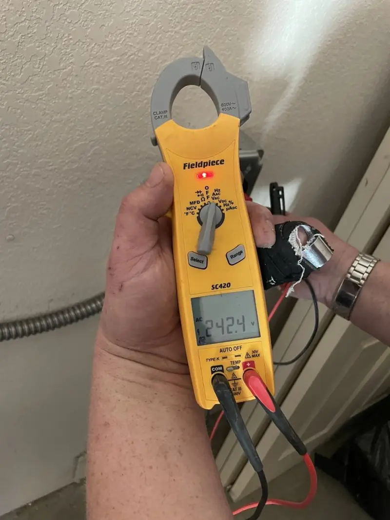 Voltage testing with clamp meter during Outlet Installation in Greenacres